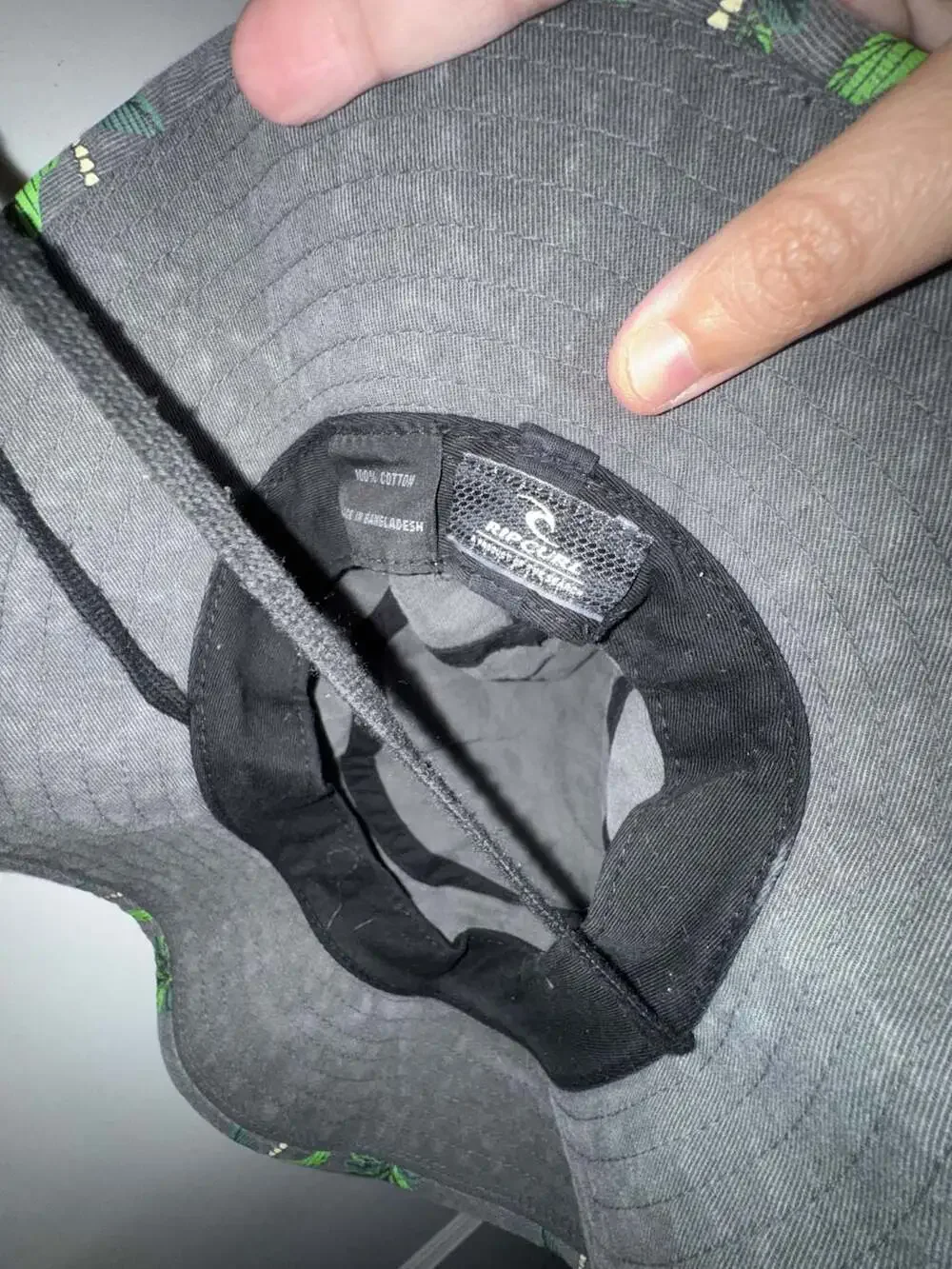 Rip Curl grey bucket hat with green palm tree print